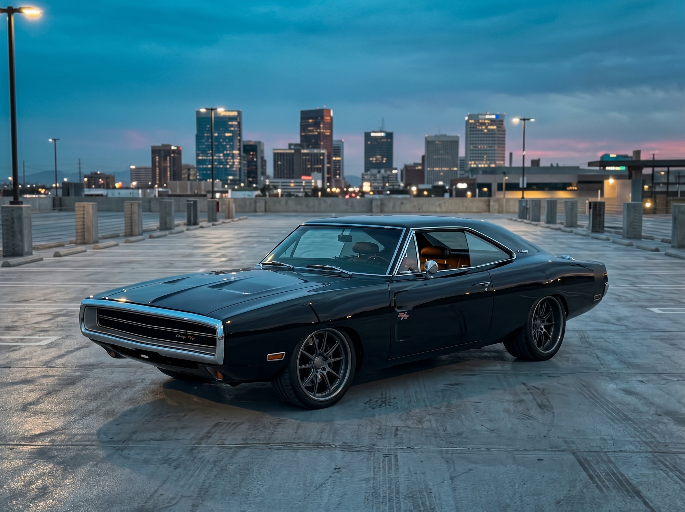 Slammed pro touring 1970 Dodge Charger R/T in deep gloss black on a Phoenix rooftop parking deck at blue hour with the downtown Phoenix skyline glowing on the horizon, representing the pro touring and restomod build philosophy.