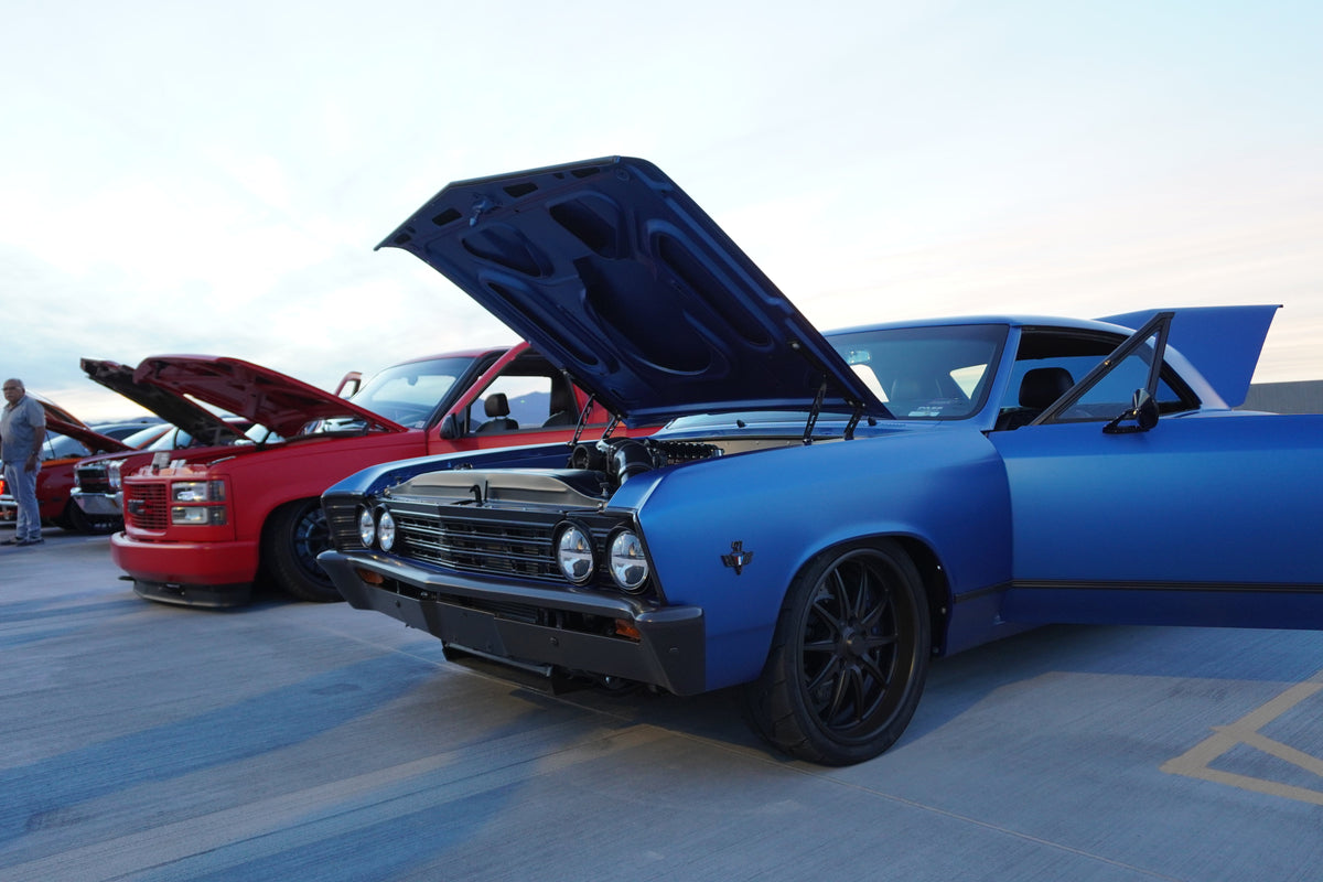 Matte blue 1967 Chevelle SS Fesler build with the hood up on the Desert Diamond rooftop at sunset