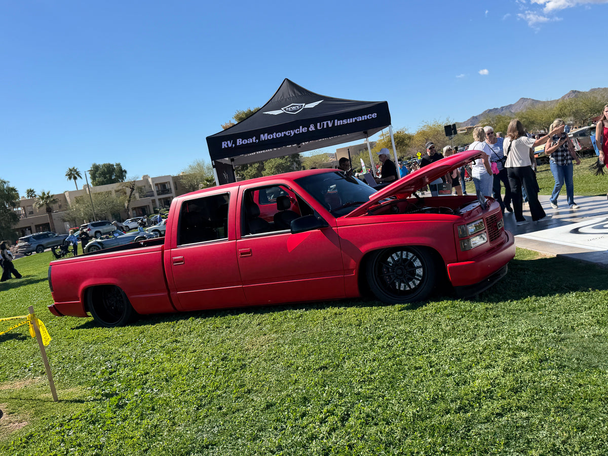 Fesler's matte red OBS shop truck, passenger side, at a classic car show in Arizona