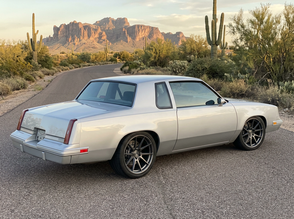 Oldsmobile Cutlass Supreme rear three-quarter view showing flush-mounted back glass and quarter glass with no chrome trim